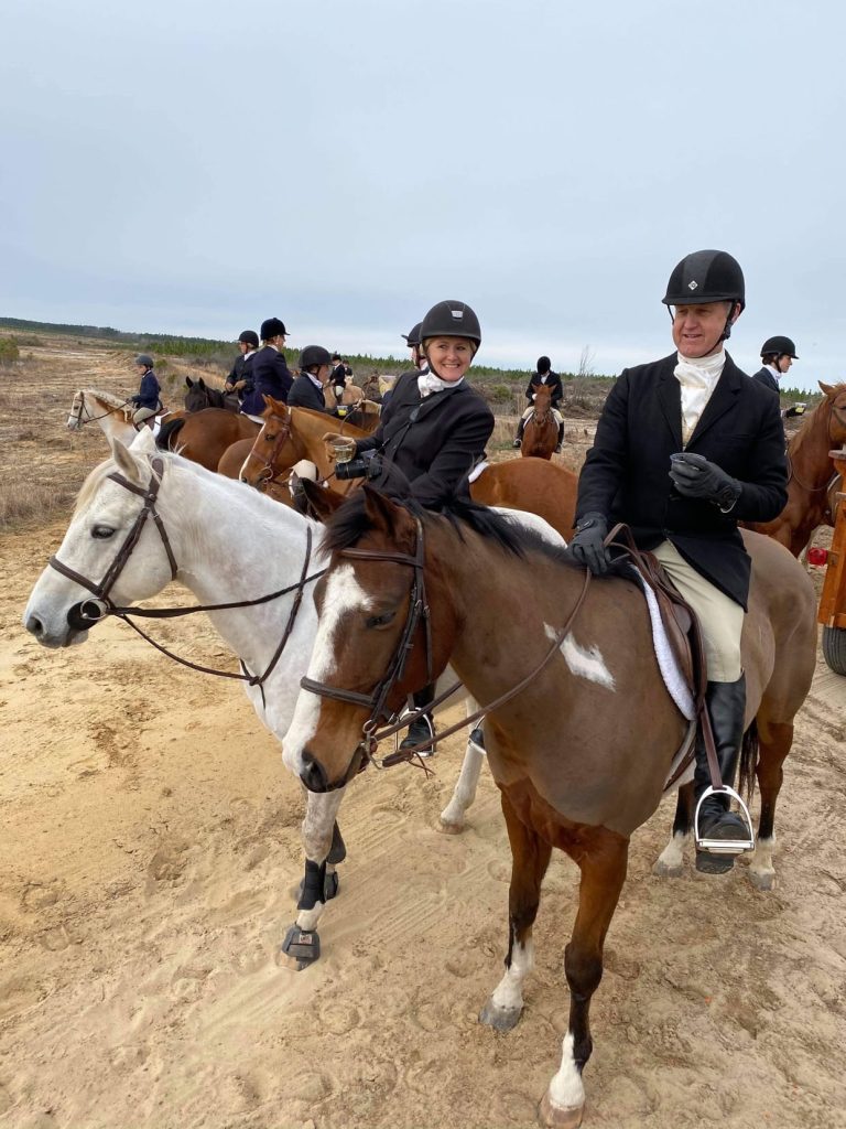 Hunt riders on horses.